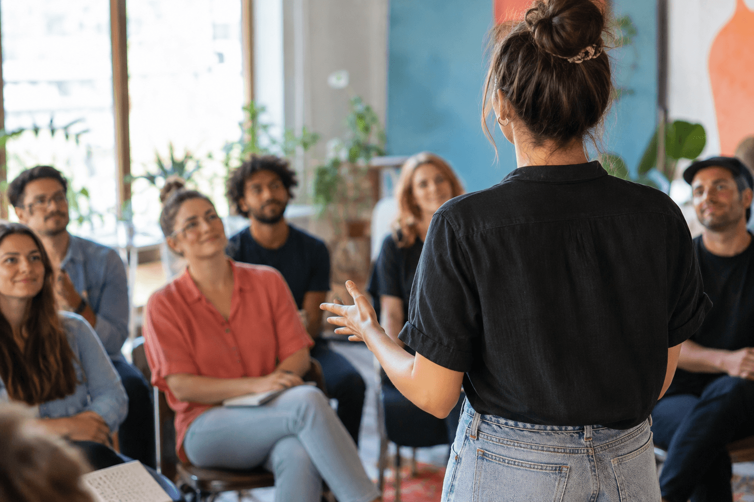 Illustrative image of a speaker addressing a small, attentive audience